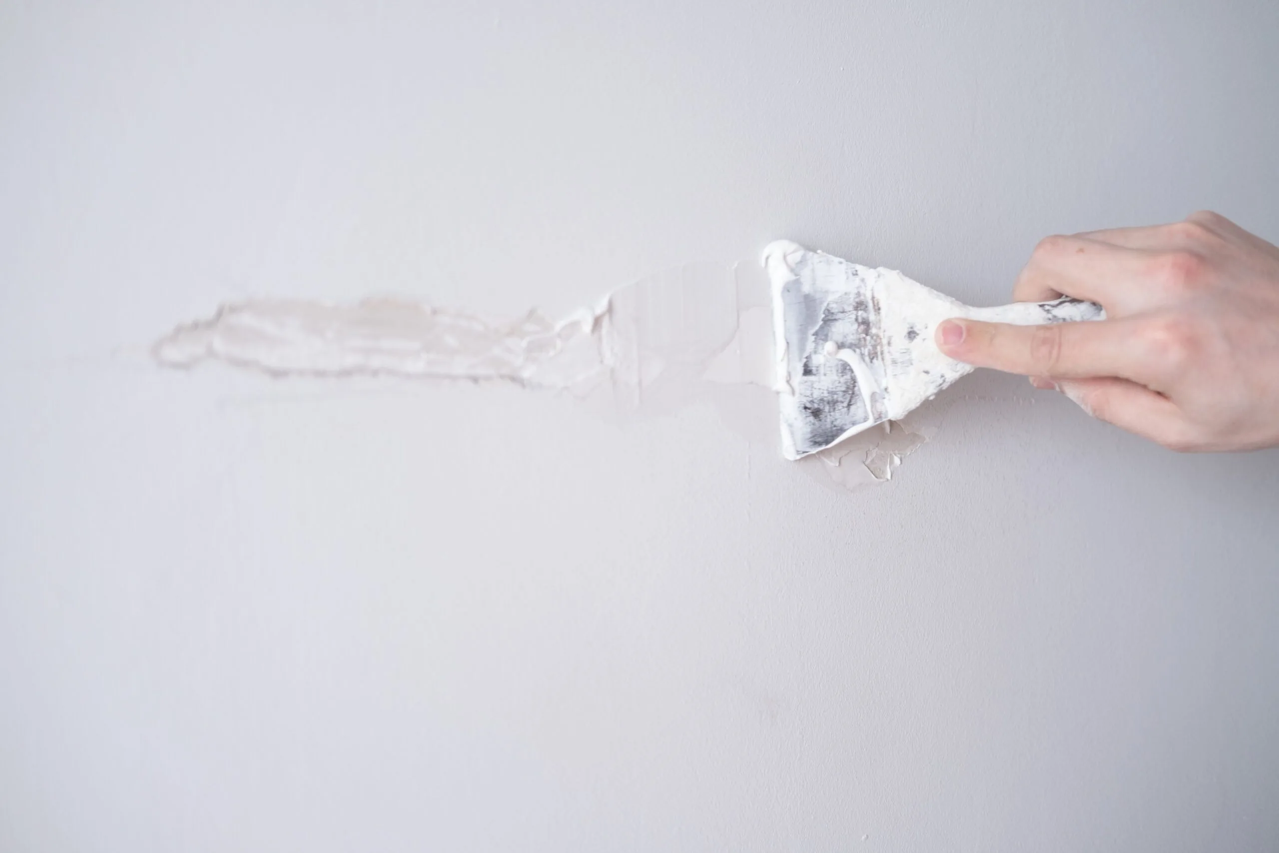 Repairing walls with putty spatula