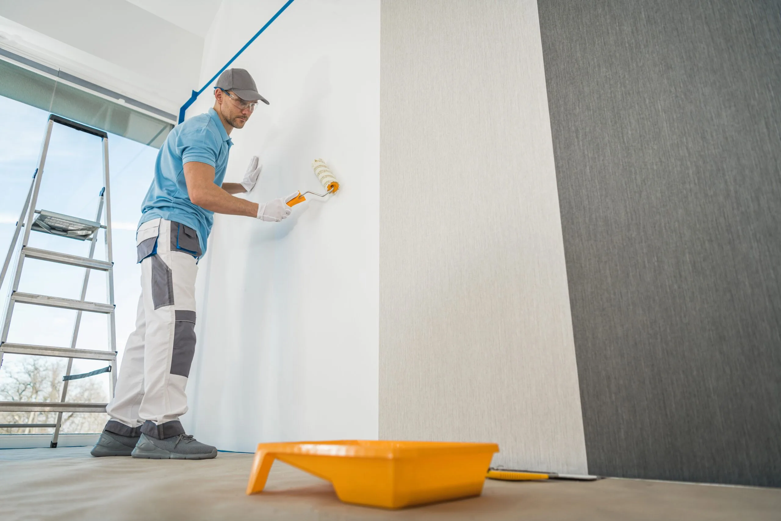 Men applying vinyl wallpaper room