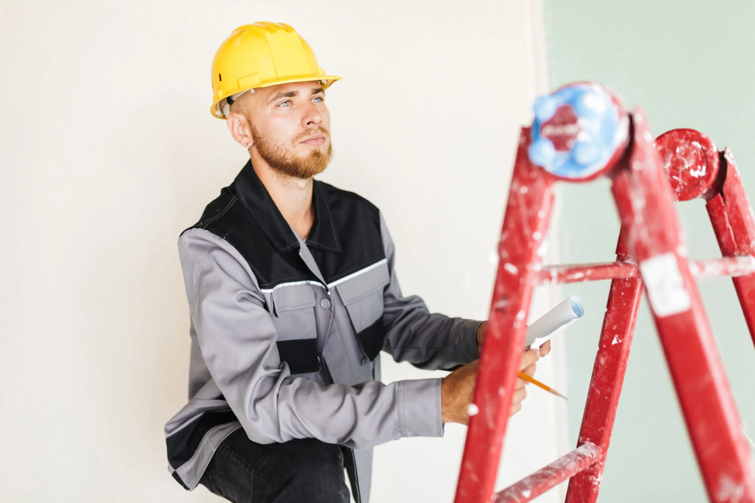 Young engineer in work clothes and a yellow hard hat