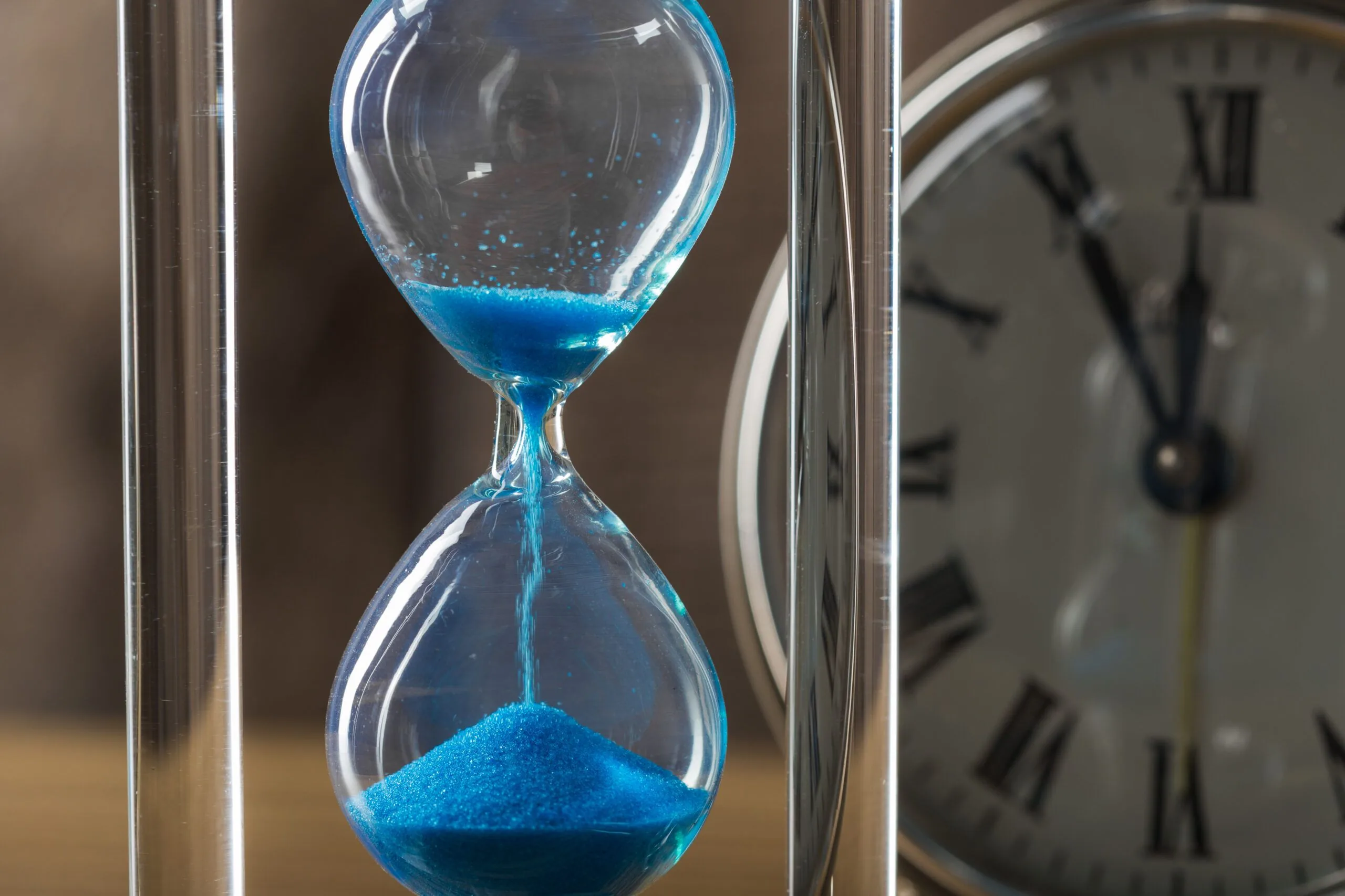 Time is passing blue hourglass close up