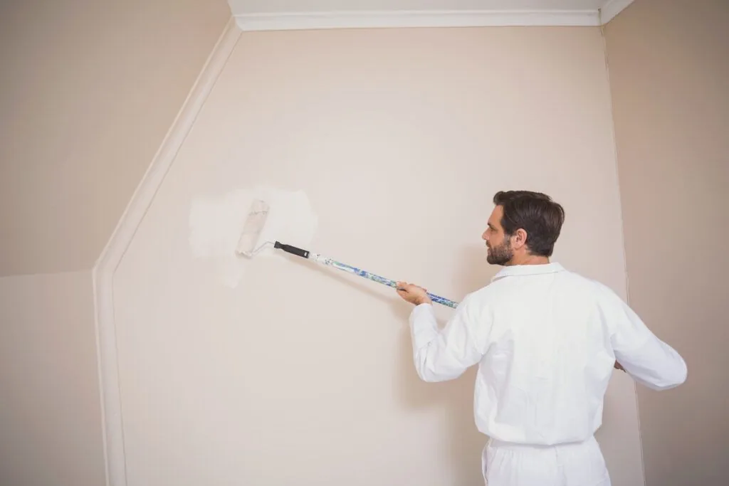 Painter painting walls white