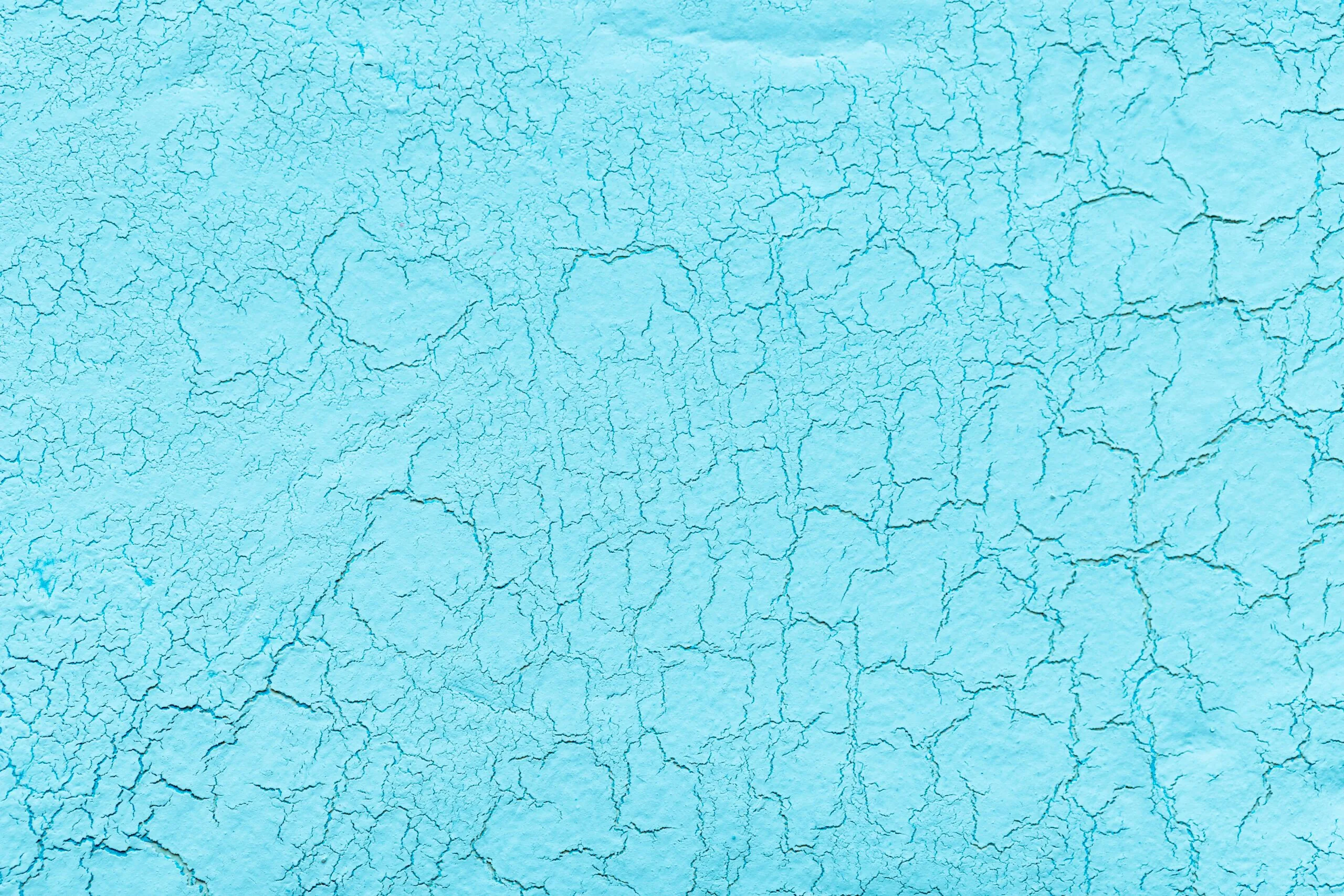 Light blue lime plaster with cracks background