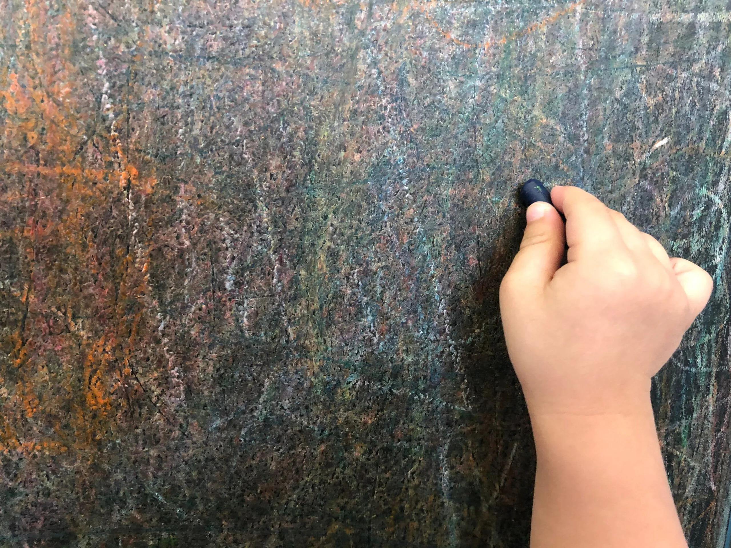 Close up hand scribbling wall