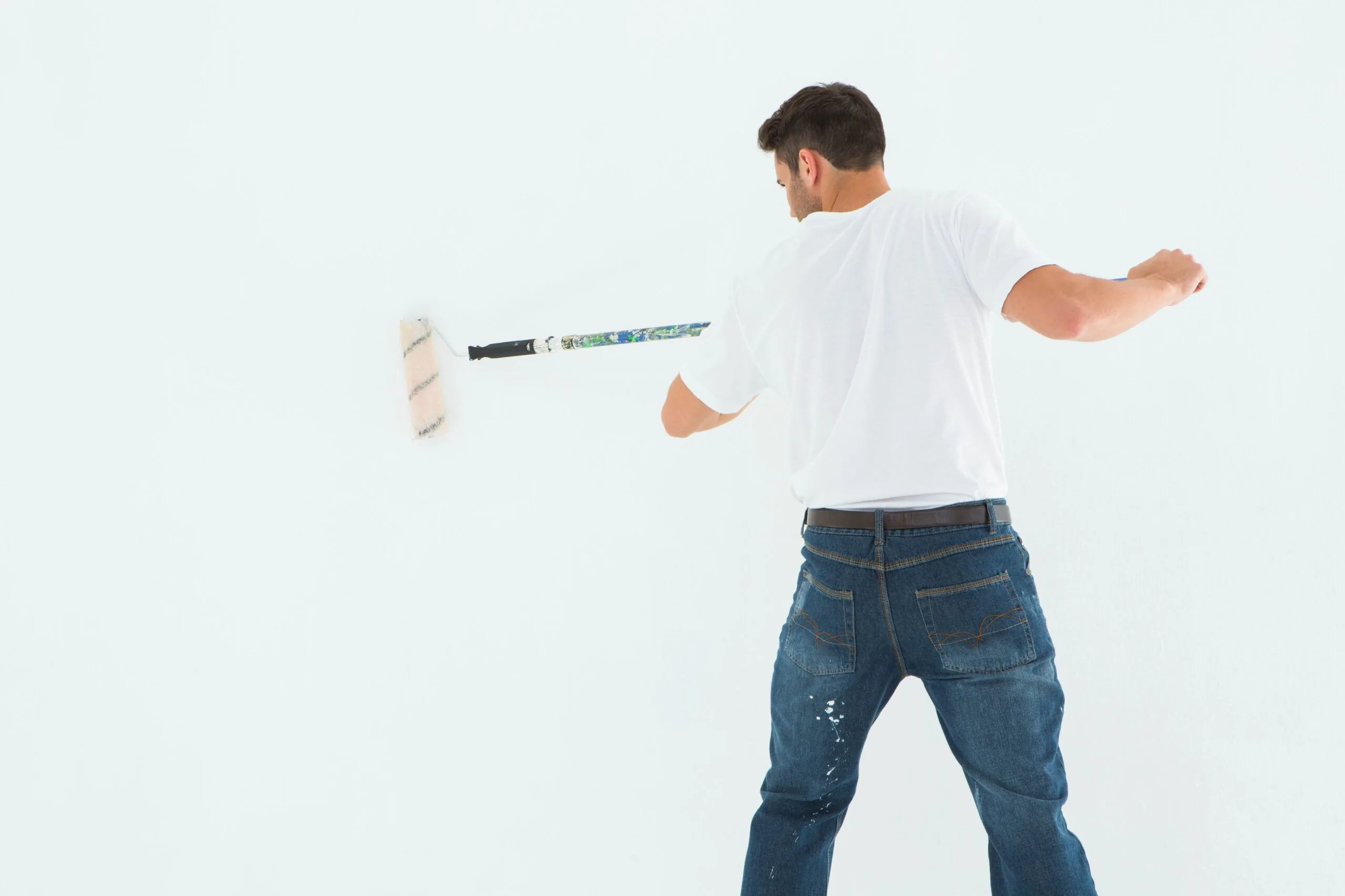 Man using paint roller white background